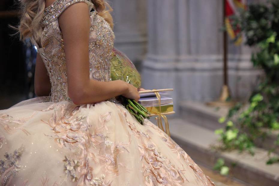 Mujer de lado posando su vestido de quinceañera para combinarlo con su peinado a domicilio