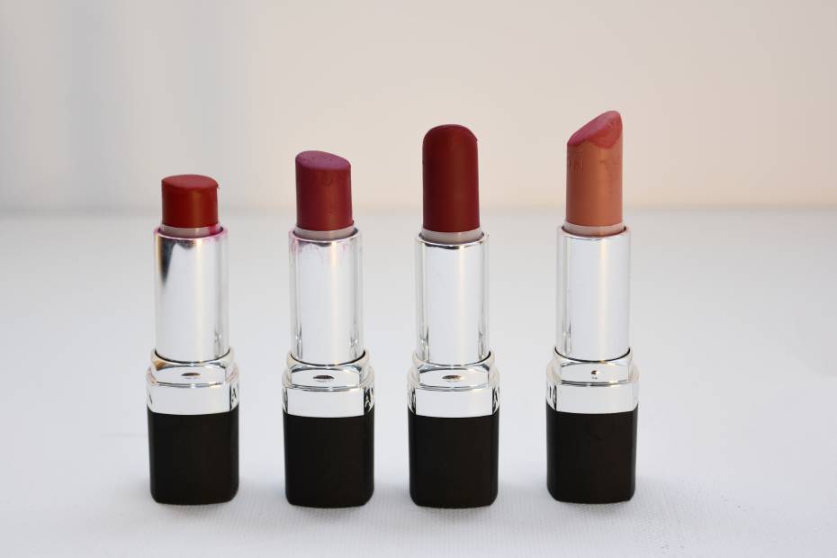 Cuatro labiales de diferentes tonos sobre una mesa, sobre las mejores marcas de lipstick para lucir labios perfectos